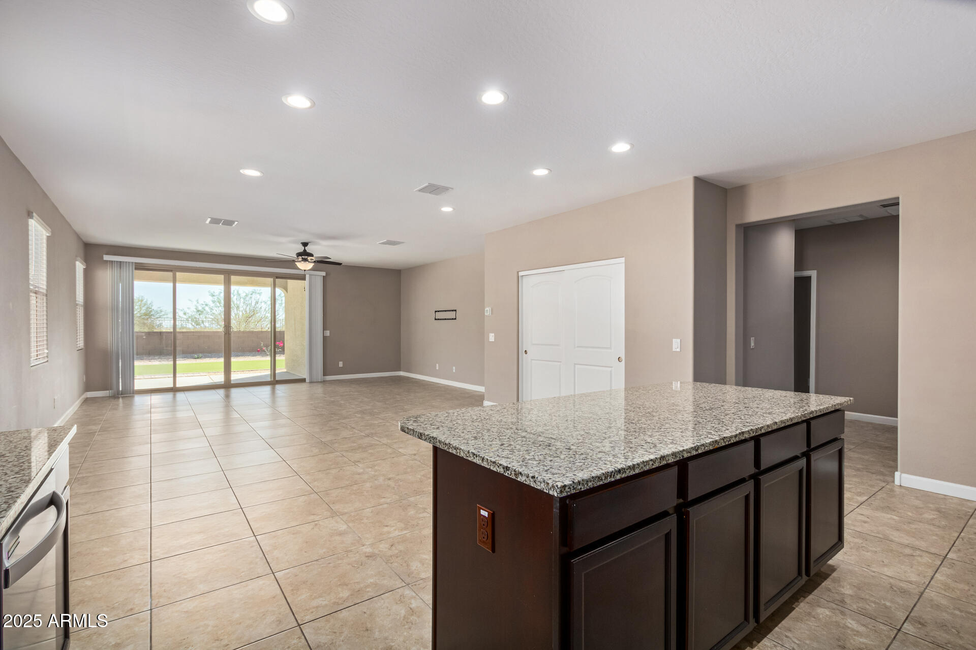 29421 West Mitchell Avenue Buckeye, AZ 85396 - Photo 9 of 40 a view of a kitchen island a sink and dishwasher with wooden floor