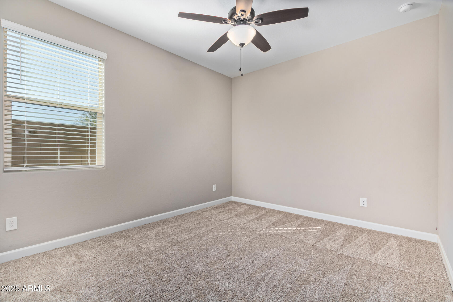 29421 West Mitchell Avenue Buckeye, AZ 85396 - Photo 19 of 40 a view of an empty room with a window
