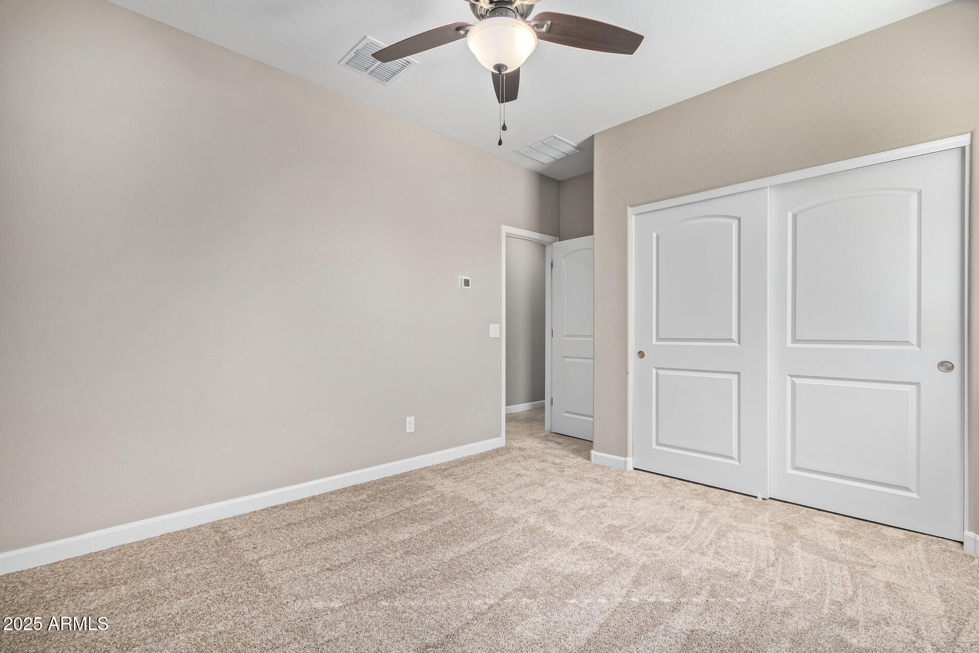 29421 West Mitchell Avenue Buckeye, AZ 85396 - Photo 20 of 40 an empty room with chandelier fan