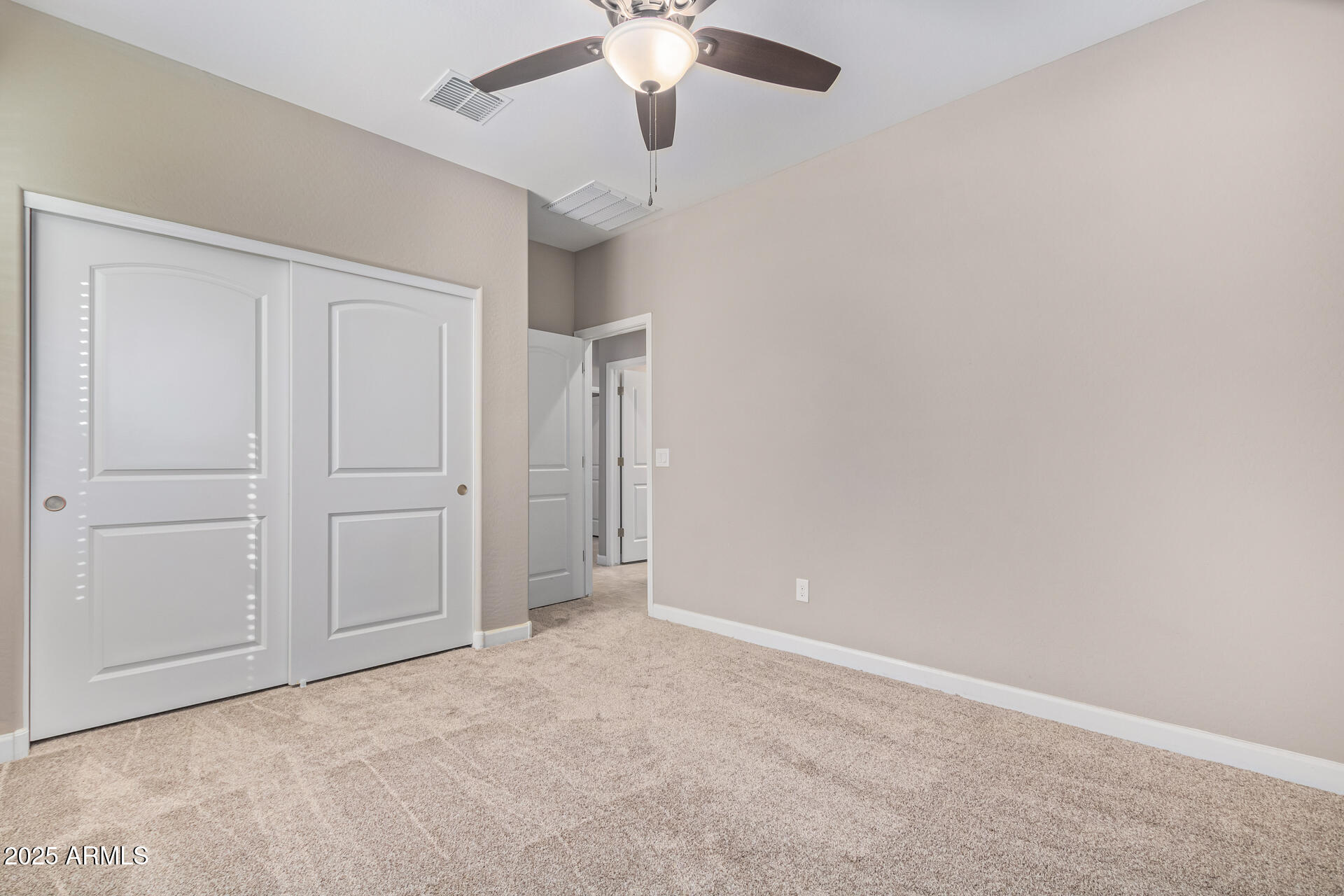29421 West Mitchell Avenue Buckeye, AZ 85396 - Photo 21 of 40 an empty room with chandelier fan