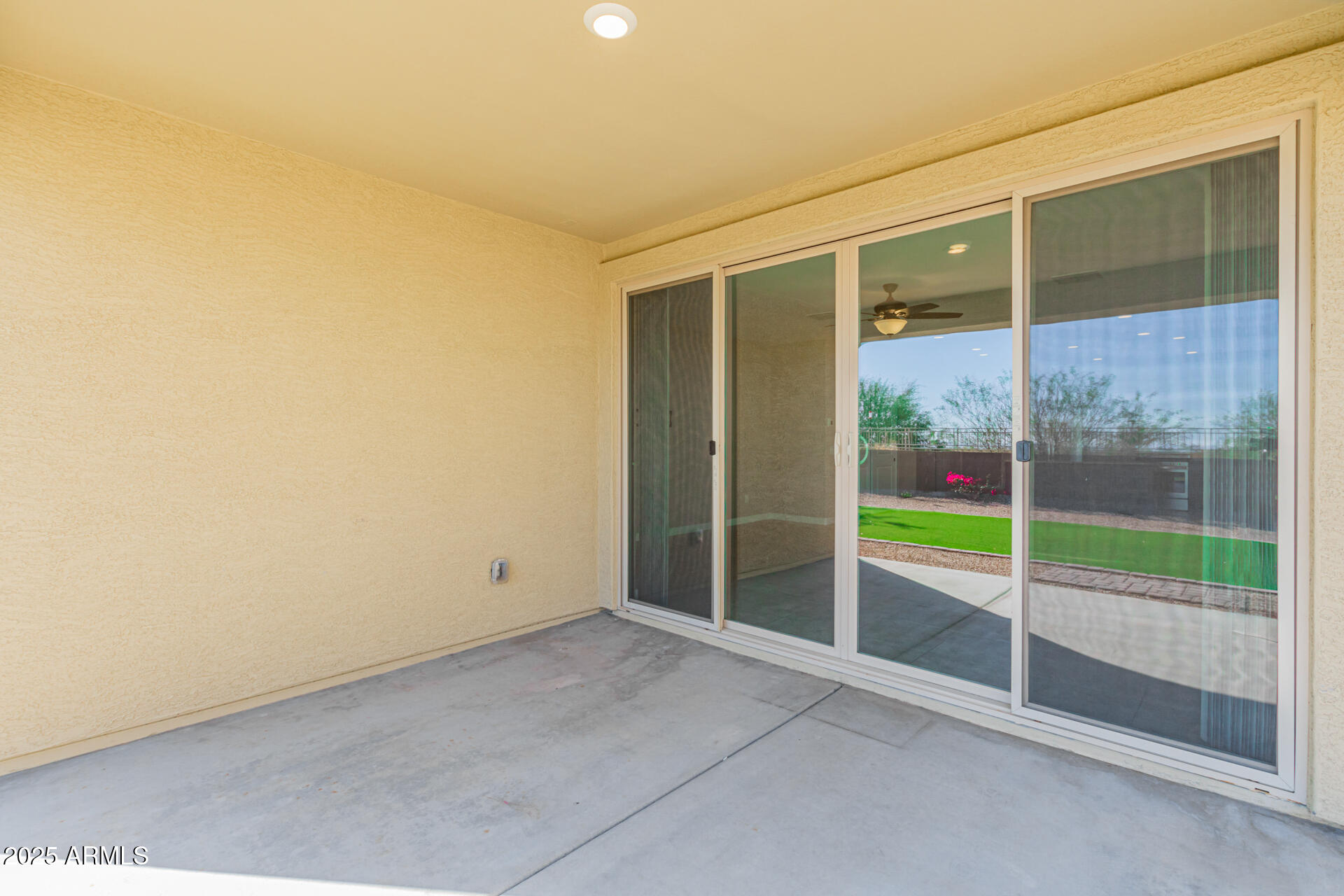29421 West Mitchell Avenue Buckeye, AZ 85396 - Photo 27 of 40 a view of an empty room with a sliding door