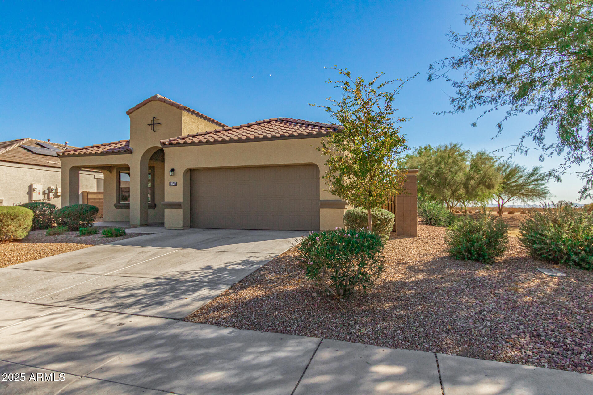 29421 West Mitchell Avenue Buckeye, AZ 85396 - Photo 4 of 40 a front view of a house with a yard and garage