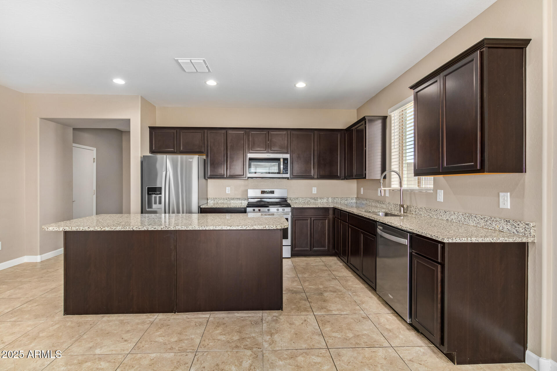 29421 West Mitchell Avenue Buckeye, AZ 85396 - Photo 8 of 40 a large kitchen with stainless steel appliances lots of counter top space
