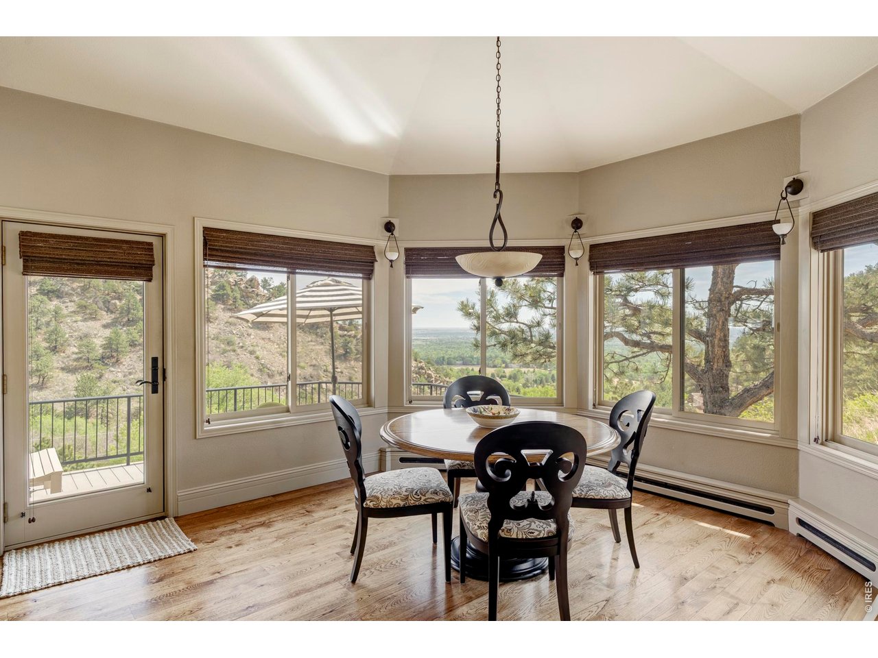 86 South Cedar Brook Road Boulder, CO 80304 - Photo 11 of 40 a view of a dining room with furniture large windows and wooden floor