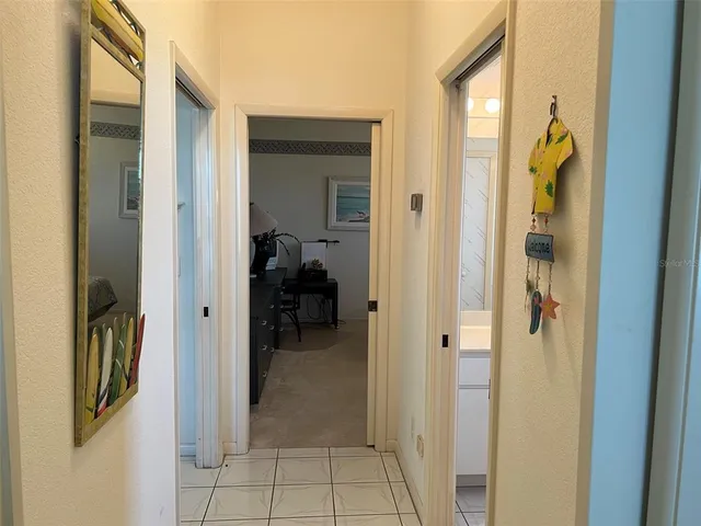 a view of a hallway with a livingroom and a rooms