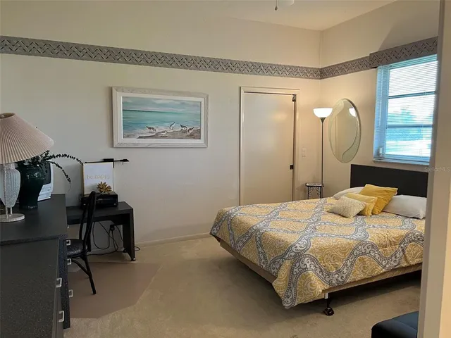 a bedroom with a bed and with furniture