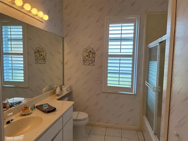 a bathroom with a sink toilet and window