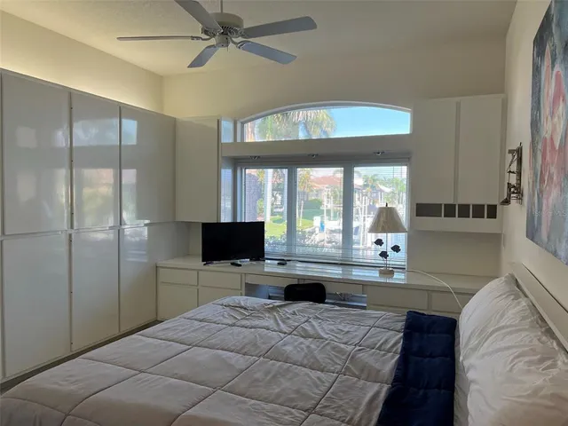 a bedroom with a large bed and a flat screen tv