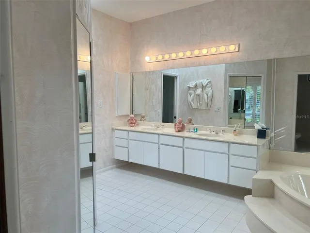 a bathroom with a double vanity sink mirror and double