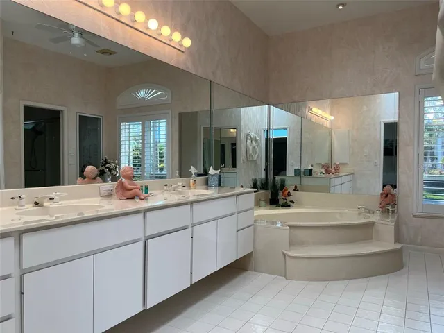 a bathroom with a double vanity sink and a mirror