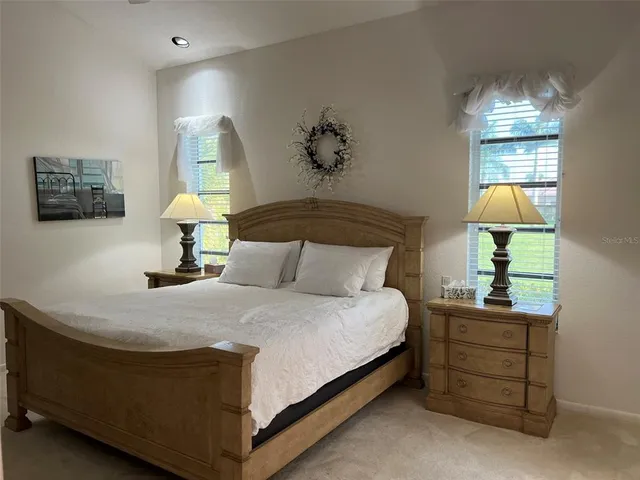 a bedroom with a bed a lamp and a chandelier