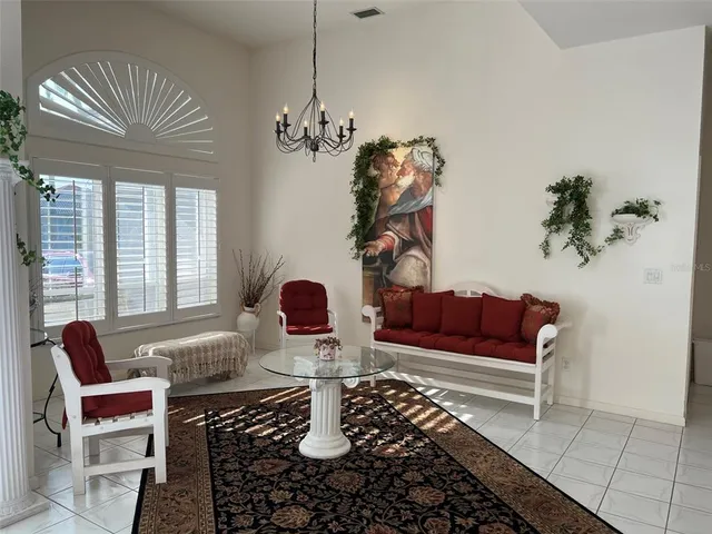 a living room with furniture and a chandelier