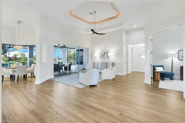 a living room with furniture and a chandelier