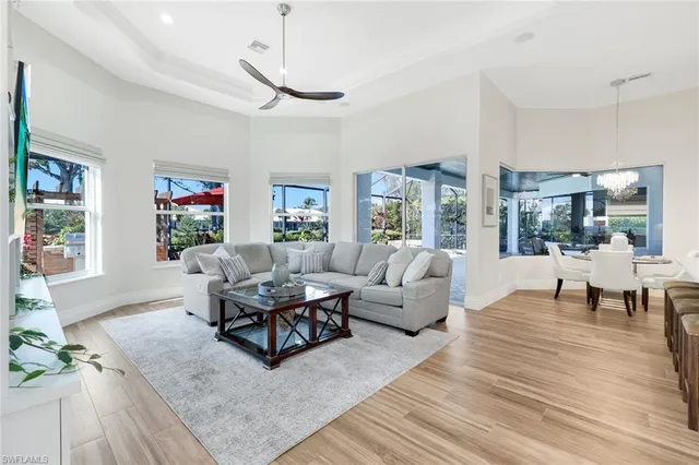 a living room with furniture large window and a table