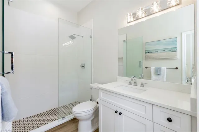 a bathroom with a sink toilet a shower and a mirror