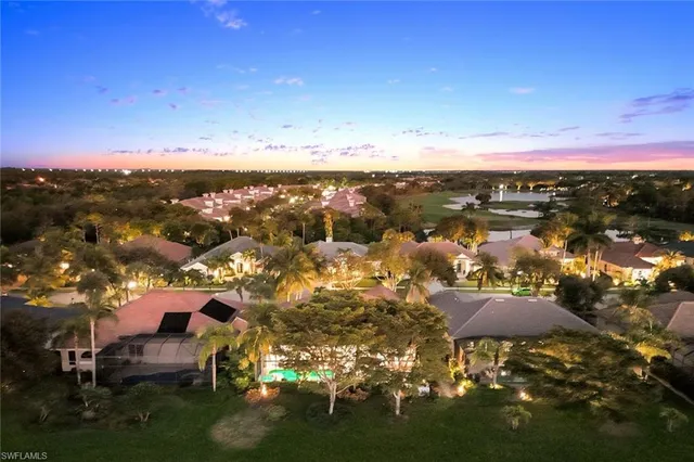 a view of a lake with houses in the background