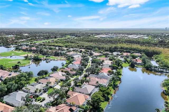 an aerial view of a houses with a swimming pool