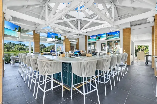 a view of swimming pool with a table and chairs in the patio