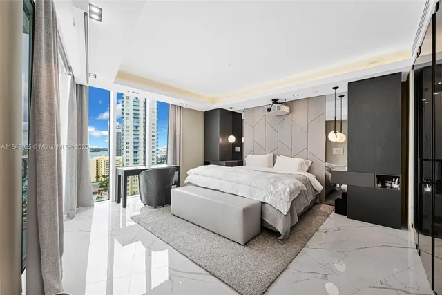 a bedroom with a large bed and a large window