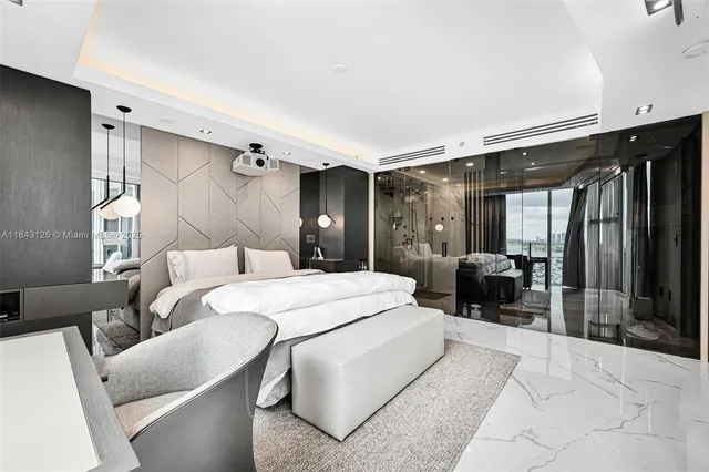 a large bedroom with a large bed and a large window