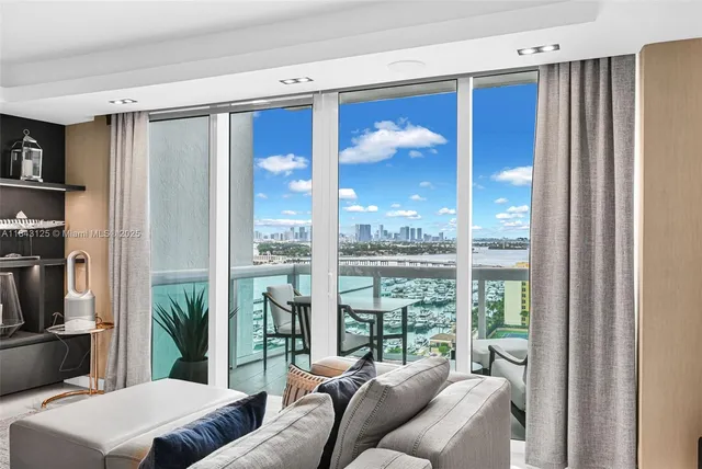 a view of a balcony with furniture and a floor to ceiling window