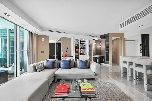 a living room with furniture a rug and a chandelier