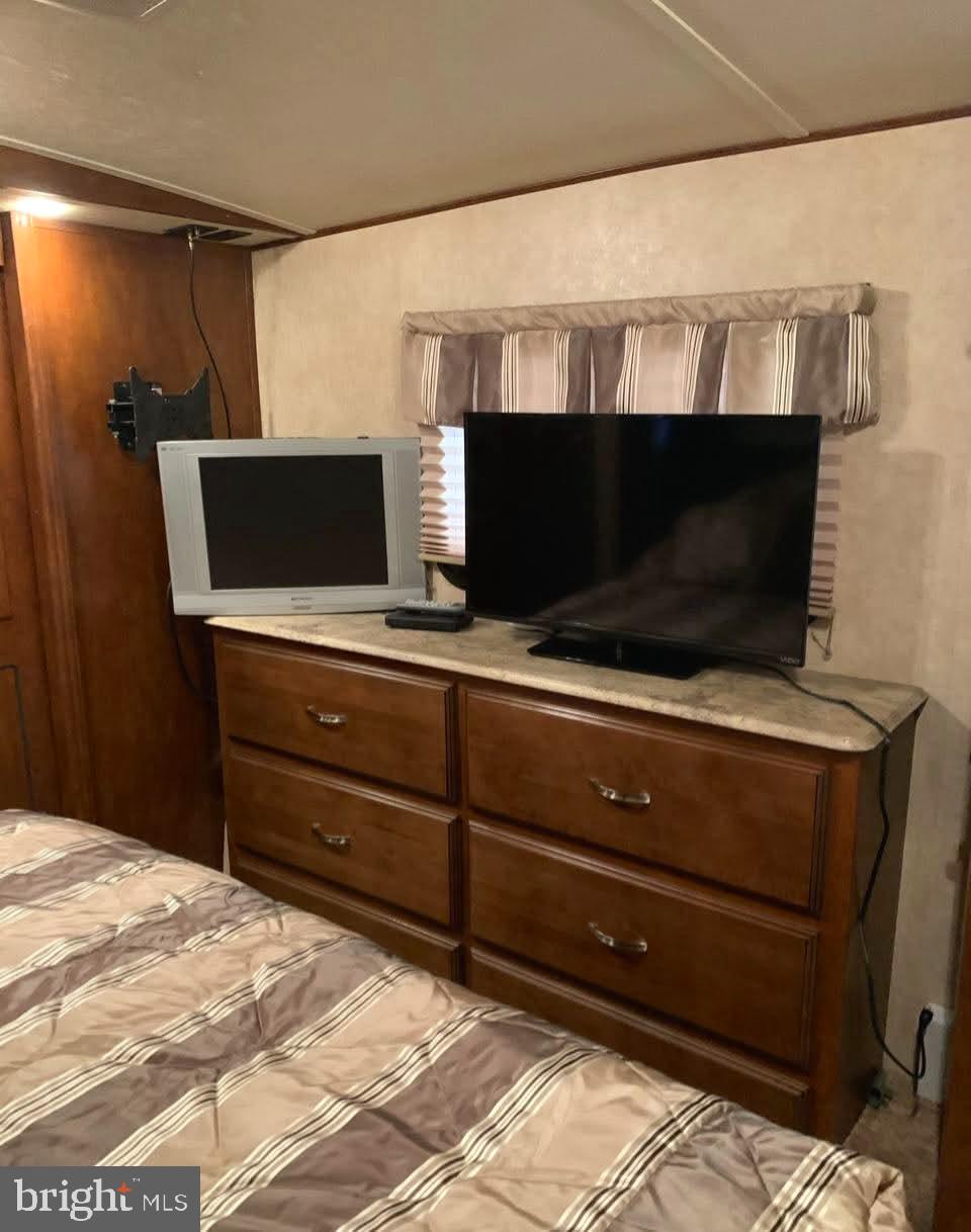 4 Butterfly Boulevard Falling Waters, WV 25419 - Photo 5 of 17 a room with a television and a bed