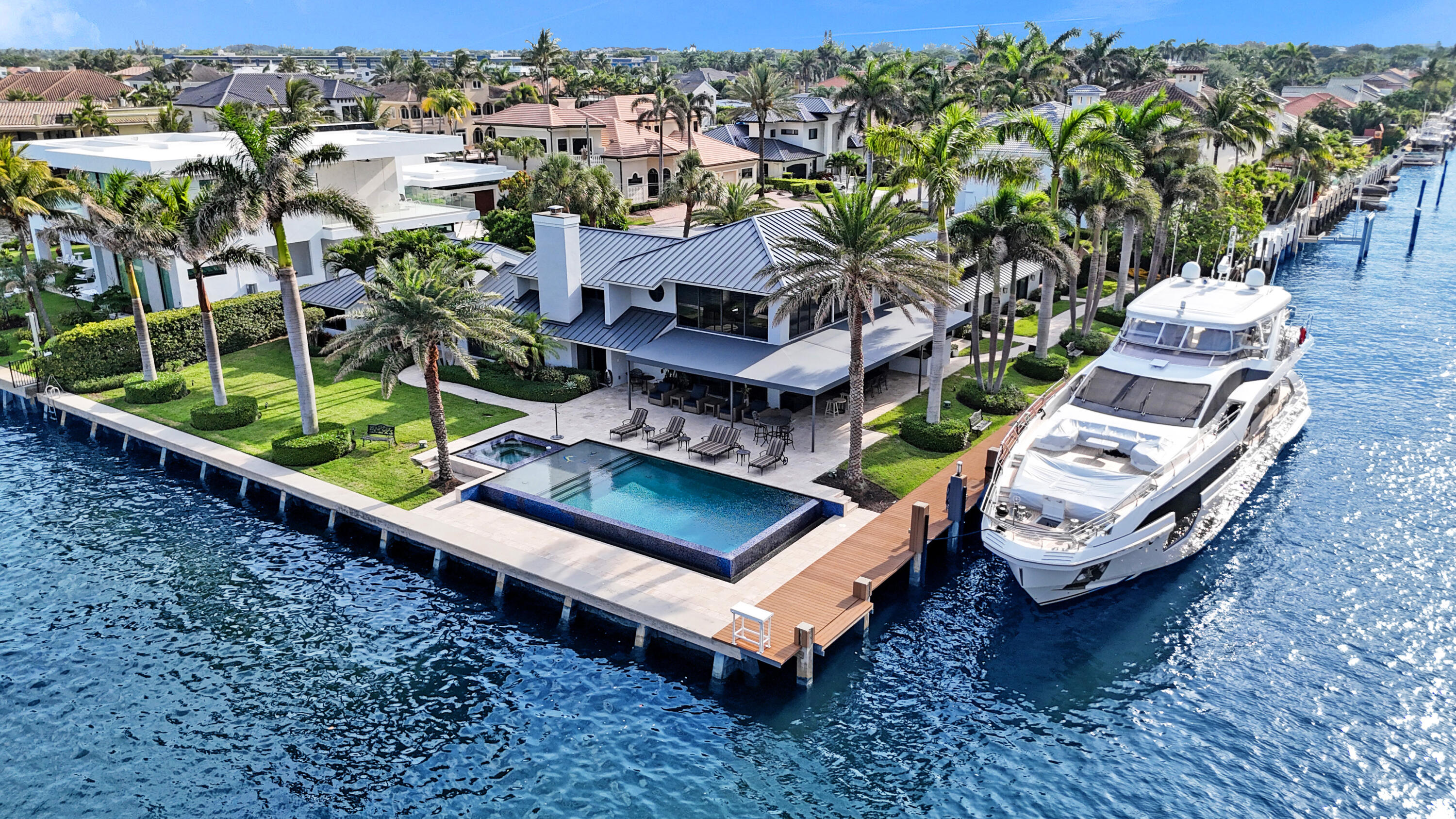 an aerial view of a house with a garden and lake view
