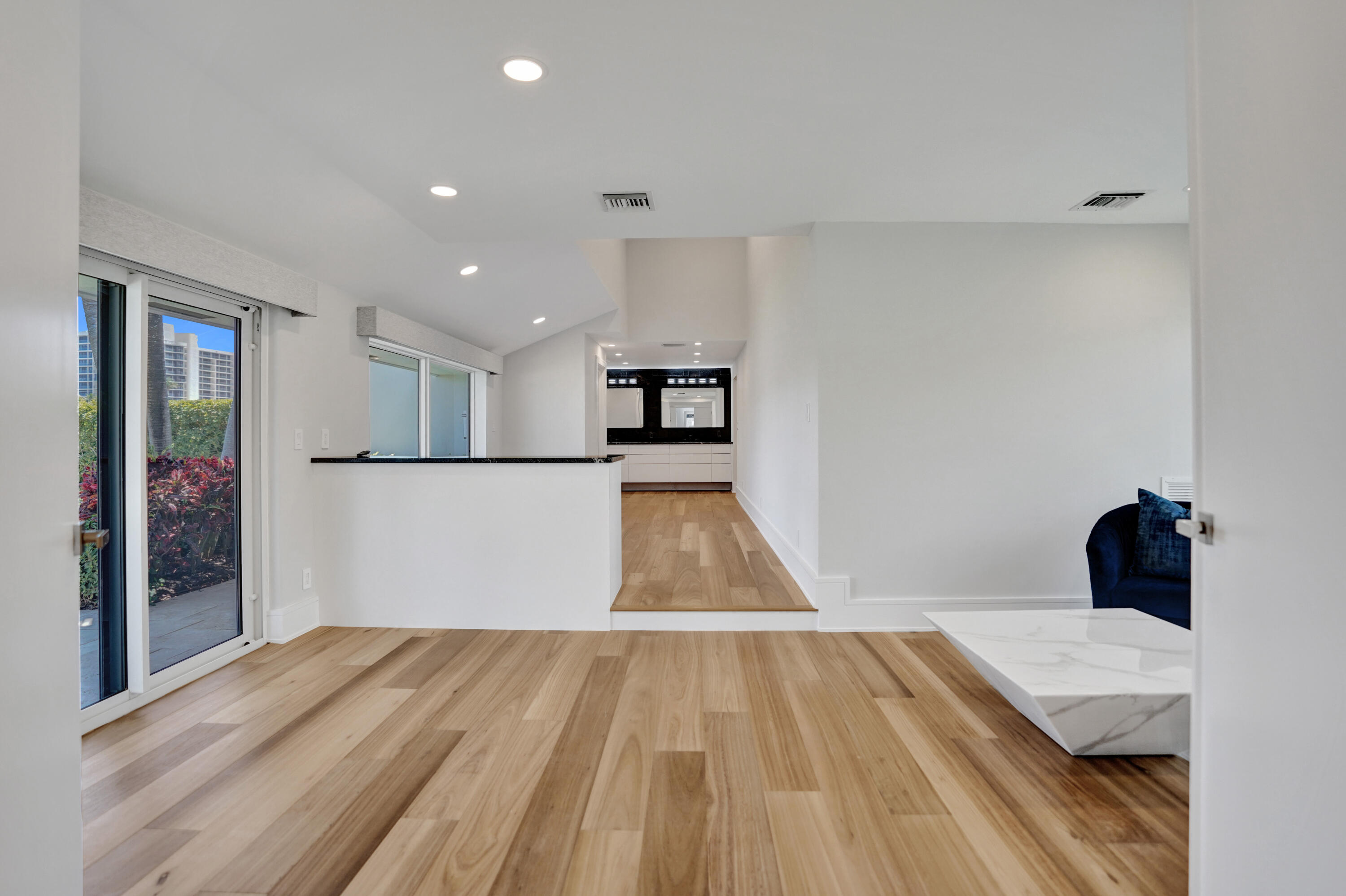 961 Iris Drive Delray Beach, FL 33483 - Photo 13 of 59 a bedroom with a bed and wooden floor