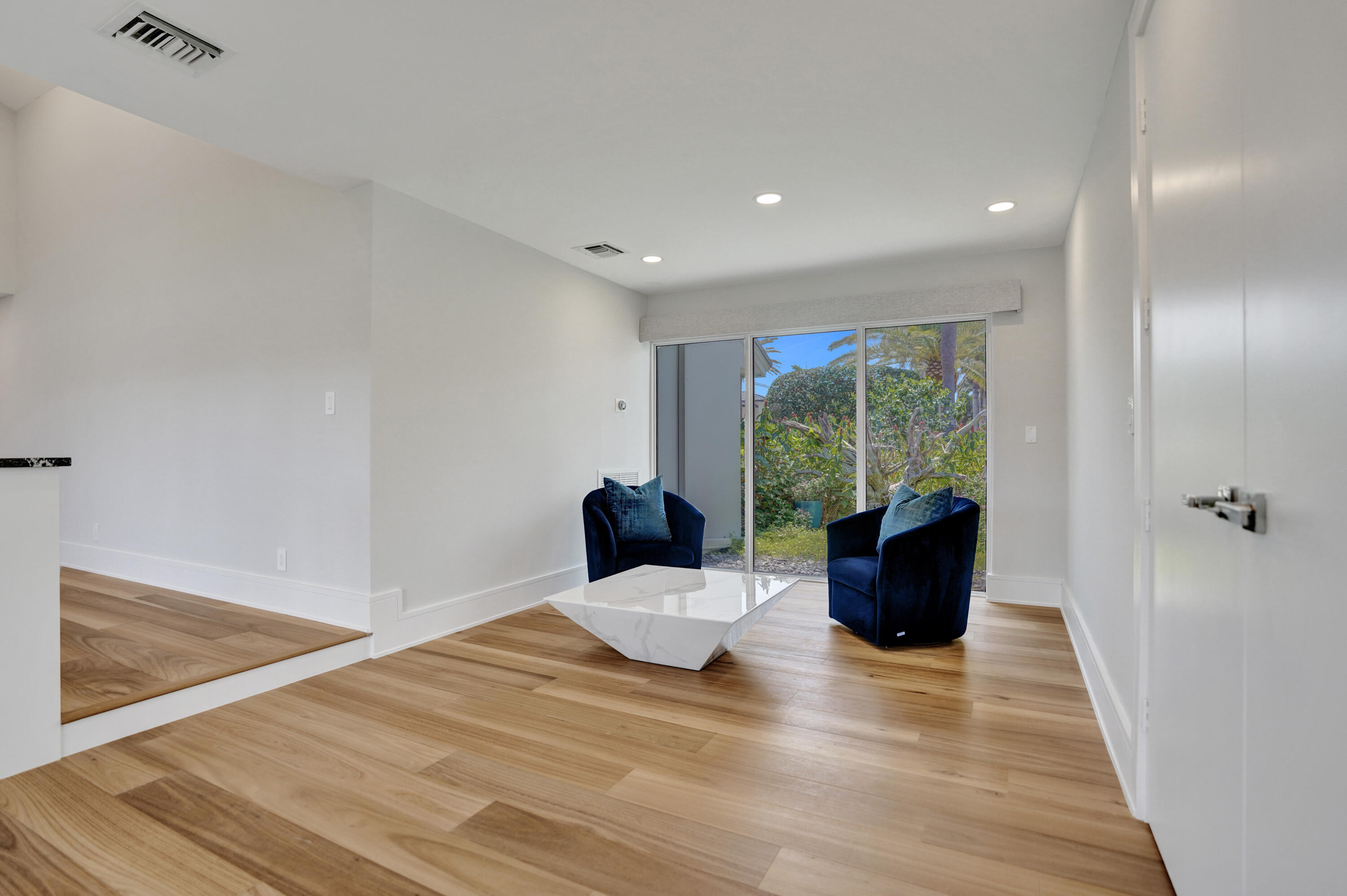 961 Iris Drive Delray Beach, FL 33483 - Photo 14 of 59 a living room with furniture large window and wooden floor