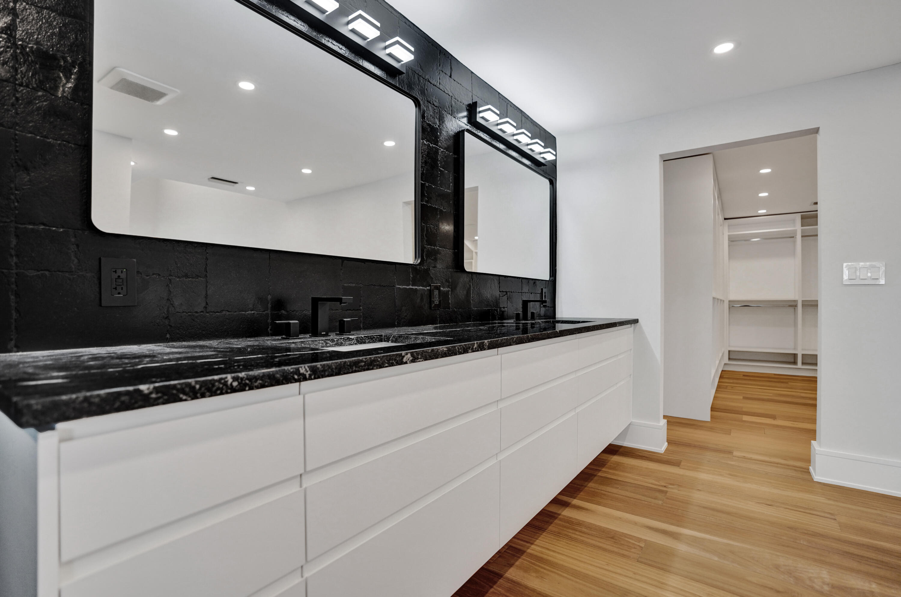 961 Iris Drive Delray Beach, FL 33483 - Photo 18 of 59 a kitchen with stainless steel appliances a sink and cabinets