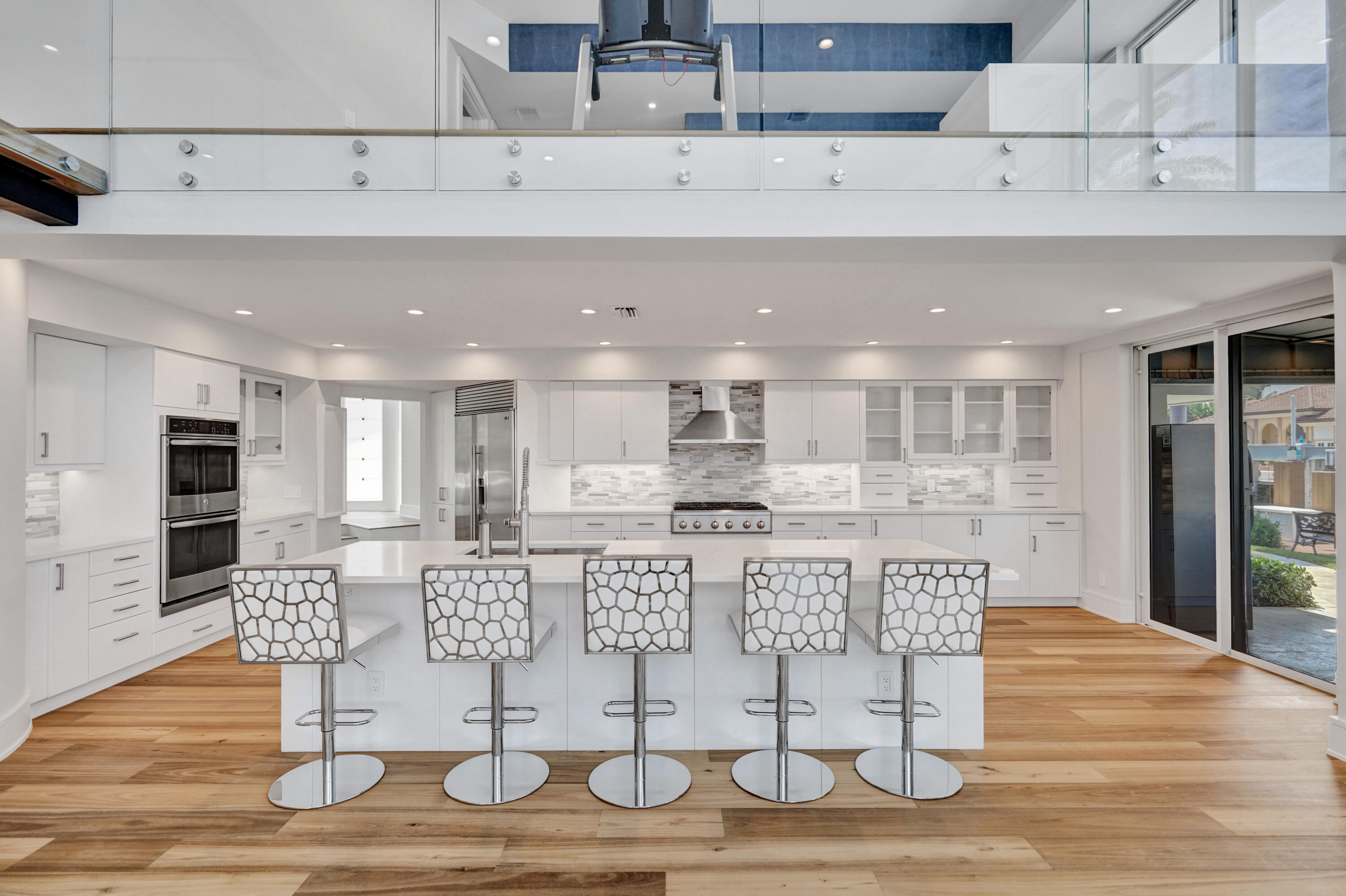 961 Iris Drive Delray Beach, FL 33483 - Photo 22 of 59 a kitchen with stainless steel appliances kitchen island granite countertop a table and chairs