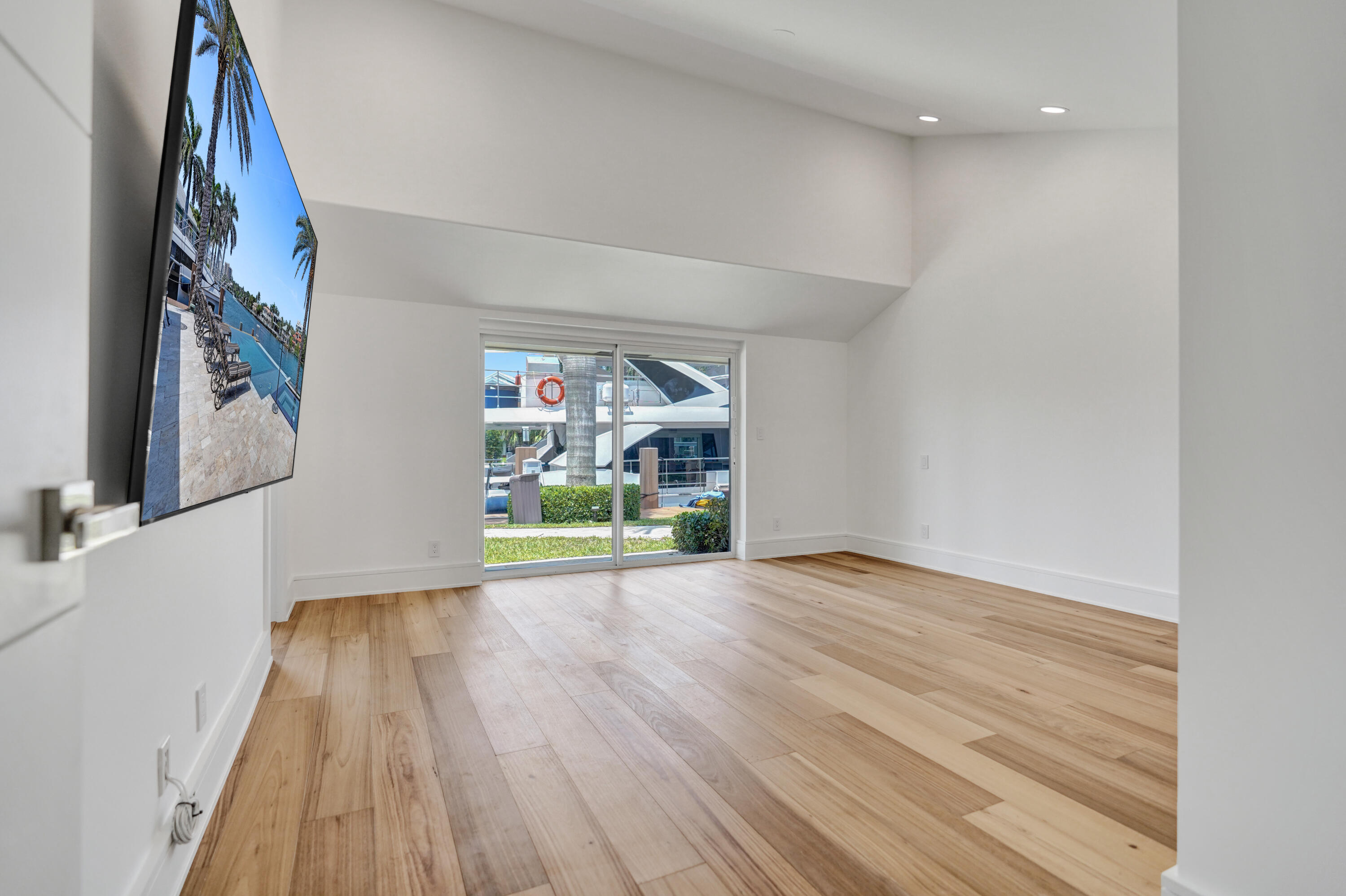 961 Iris Drive Delray Beach, FL 33483 - Photo 33 of 59 a view of an empty room with wooden floor and a window