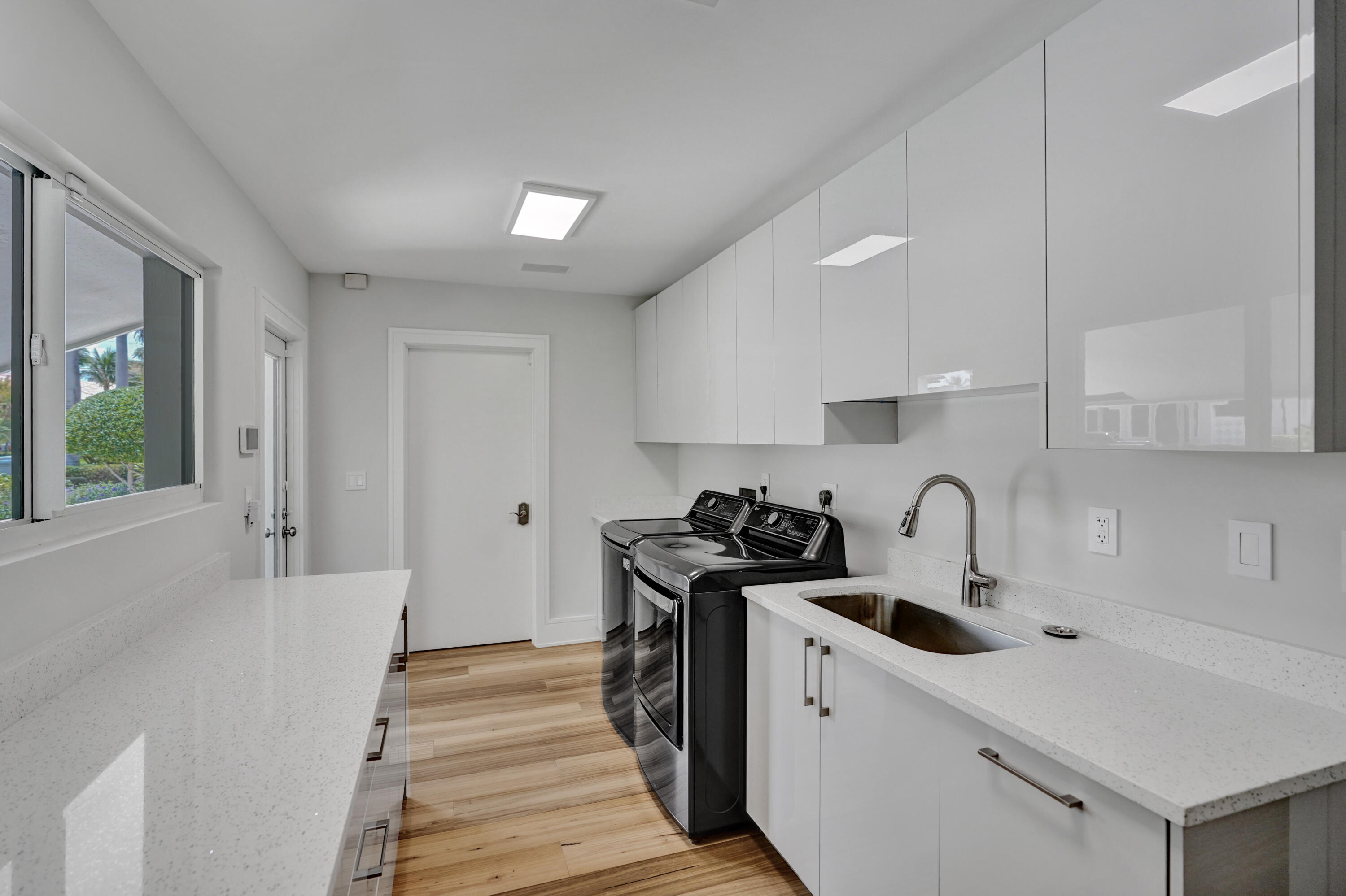 961 Iris Drive Delray Beach, FL 33483 - Photo 39 of 59 a kitchen with a sink a stove and cabinets