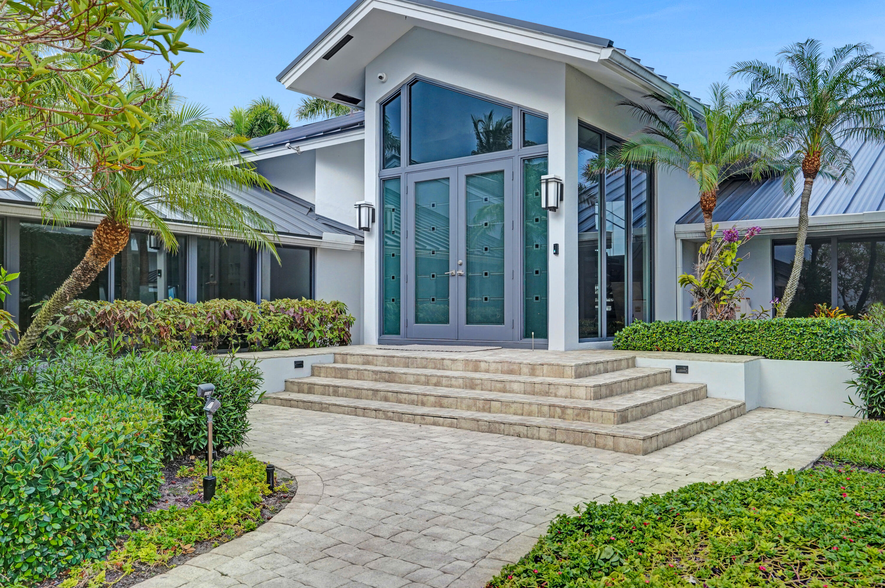 961 Iris Drive Delray Beach, FL 33483 - Photo 4 of 59 front view of a house with a small yard