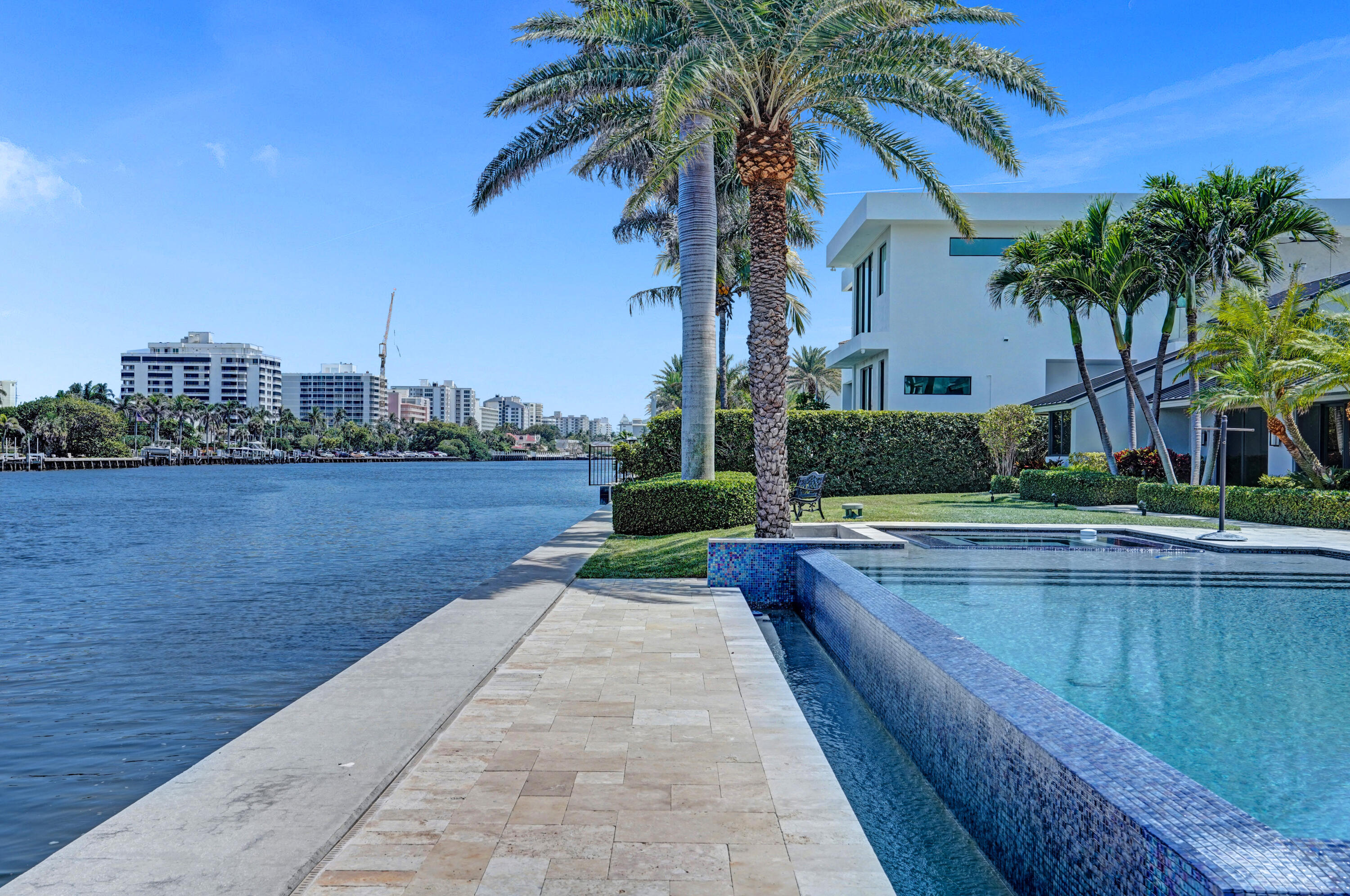 961 Iris Drive Delray Beach, FL 33483 - Photo 44 of 59 a view of swimming pool that has lawn chairs with plants and lake view