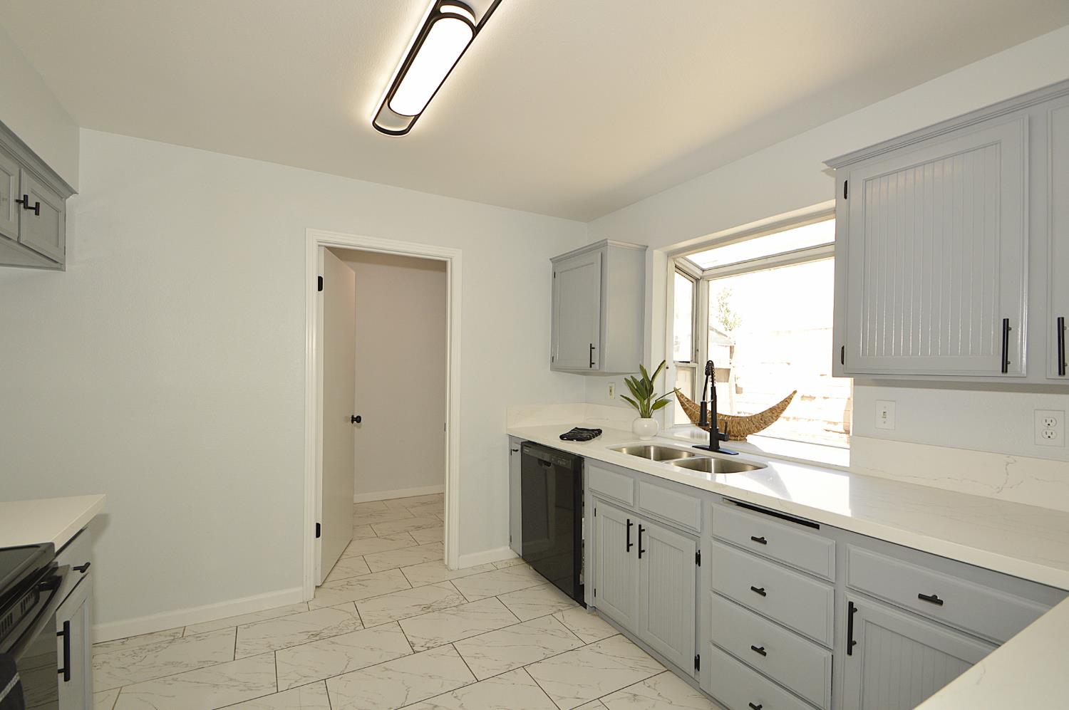 3290 North Rafael Avenue Fresno, CA 93722 - Photo 10 of 10 New quartz ounter tops, new backsplash, new appliances, new kitchen modern lighting.