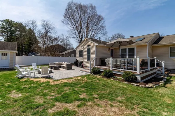 a view of a house with backyard and sitting area