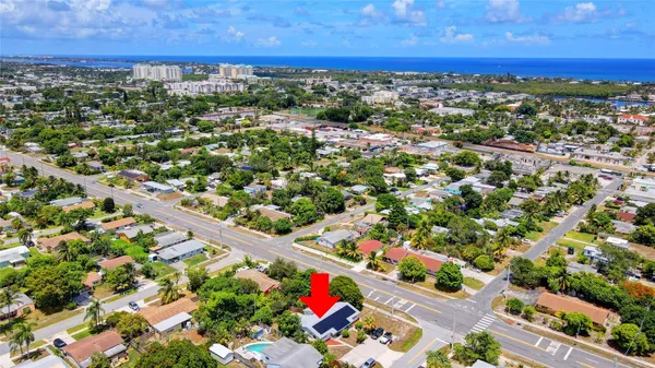 an aerial view of residential houses with outdoor space and street view
