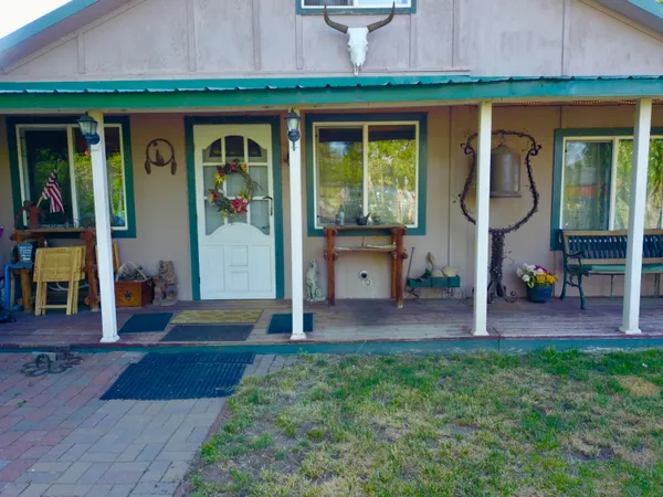 a view of a house with backyard and porch