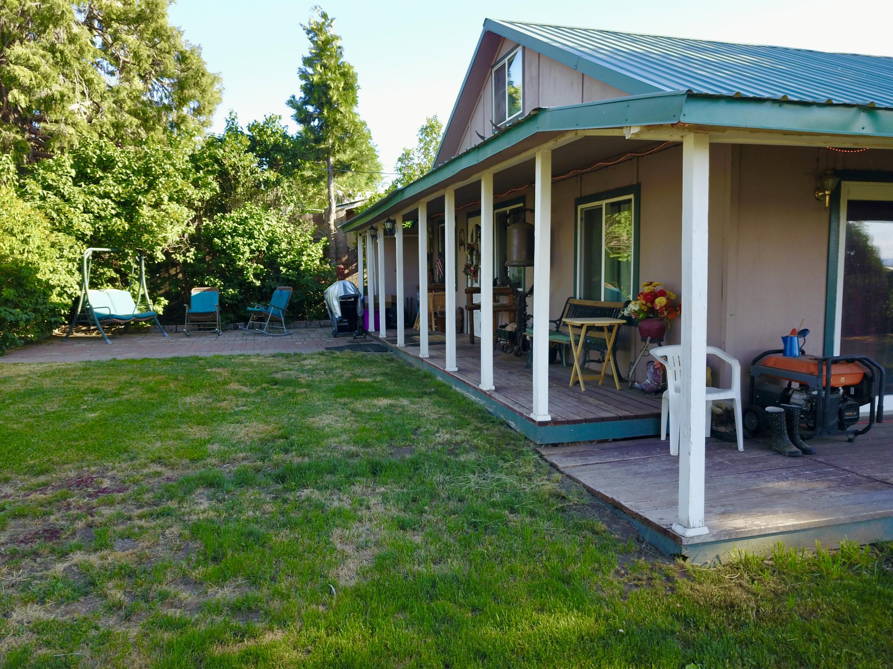 25965 Cir Bell Road Fall River Mills, CA 96028 - Photo 16 of 53 a view of a house with backyard and porch