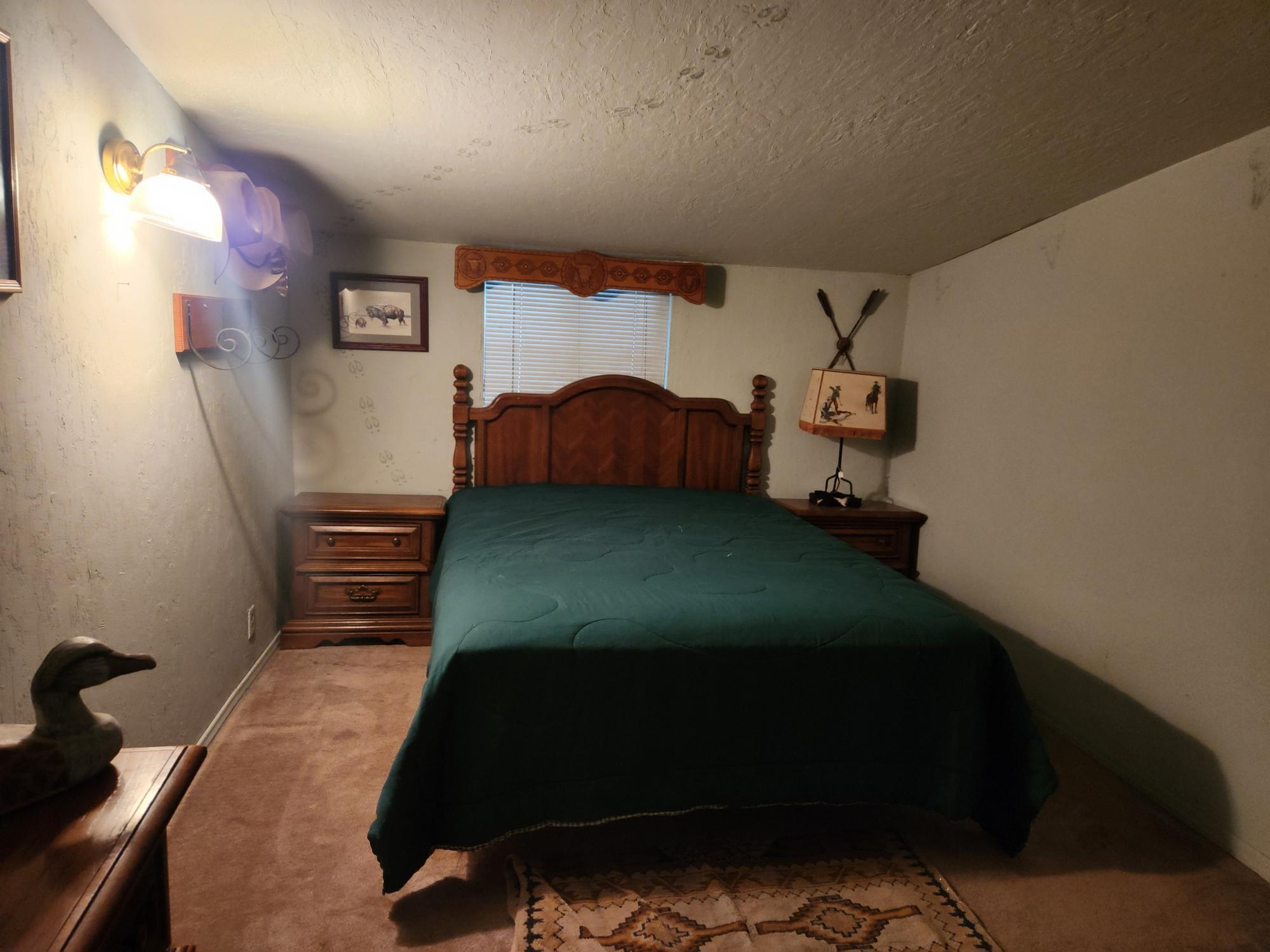 25965 Cir Bell Road Fall River Mills, CA 96028 - Photo 25 of 53 a bedroom with a bed and a painting on the wall