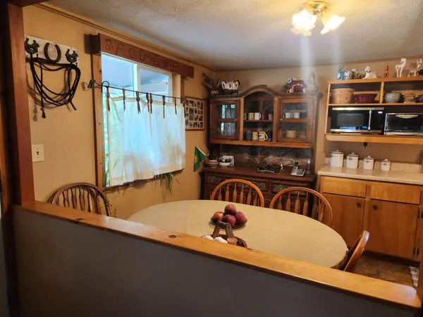 a view of a backyard with chairs and a fire pit
