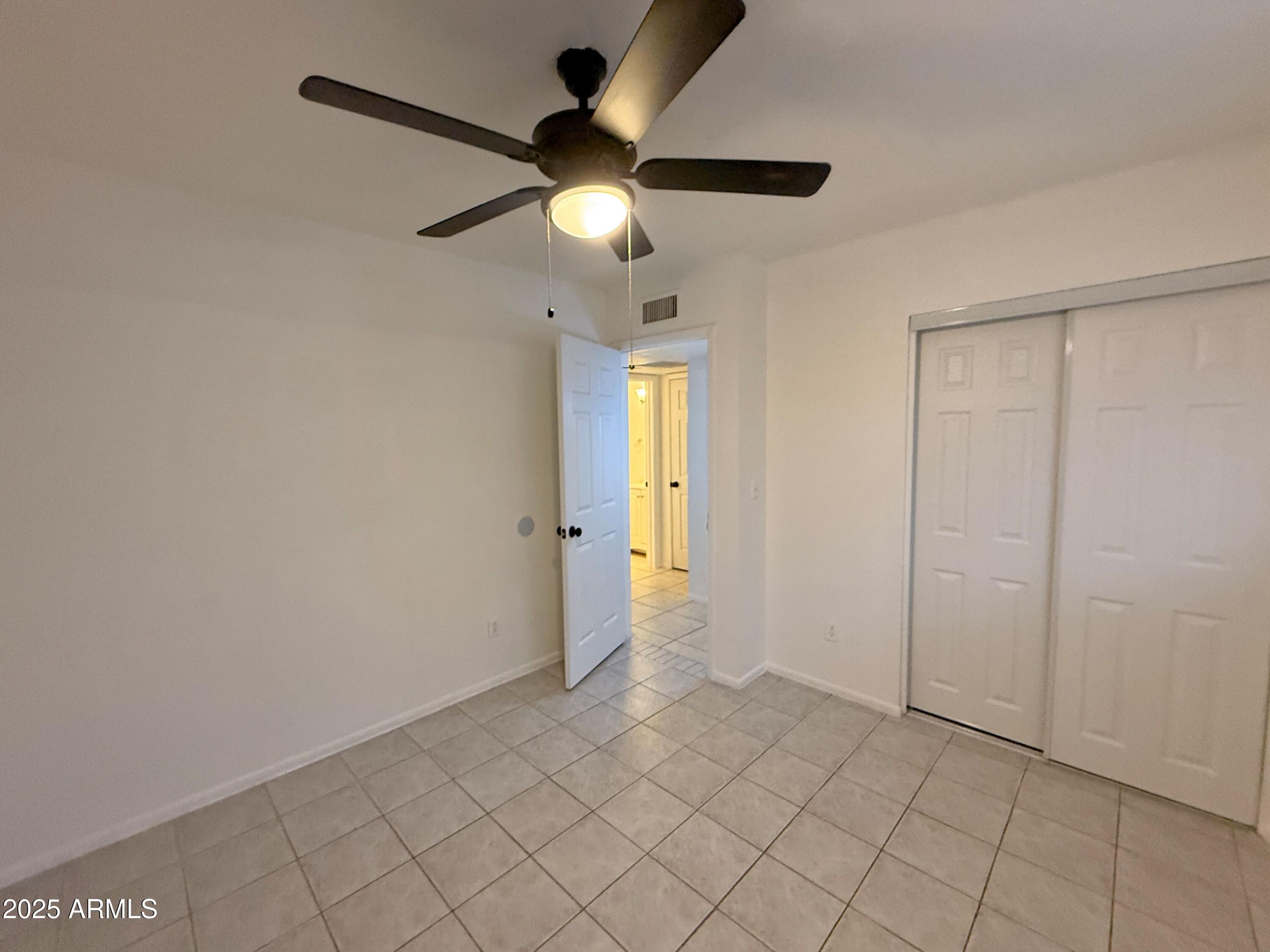3125 North 66th Street, Unit 2 Scottsdale, AZ 85251 - Photo 8 of 10 an empty room and chandelier fan