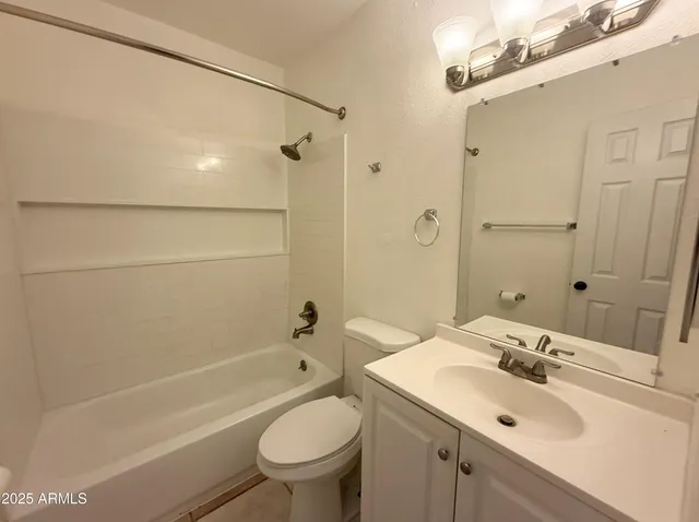 a bathroom with a sink mirror toilet and bathtub