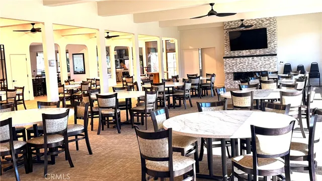 a view of a dining room with furniture window and a fireplace