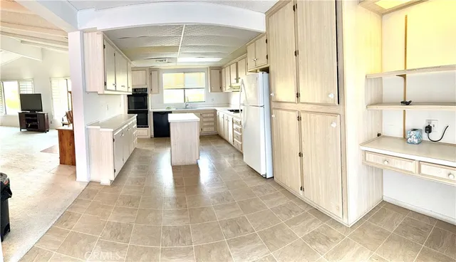 a view of a kitchen with a stove and a refrigerator