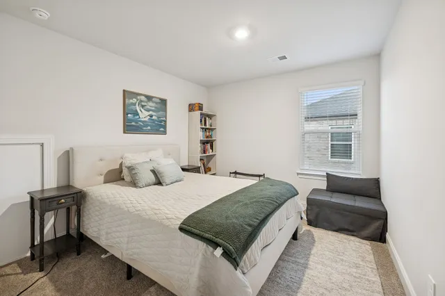 a bedroom with a bed and a couch