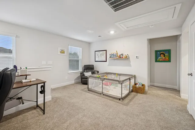 a spacious bedroom with a bed and a desk