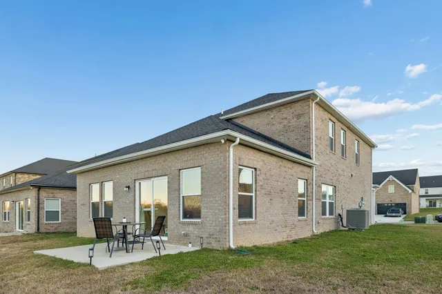a backyard of a house with table and chairs